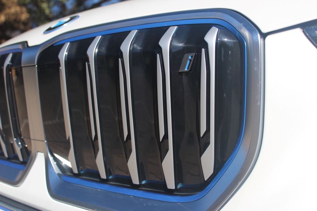 The blanked-off grille with its blue surround and tiny "i" badge are key giveaways to the iX1's EV status.