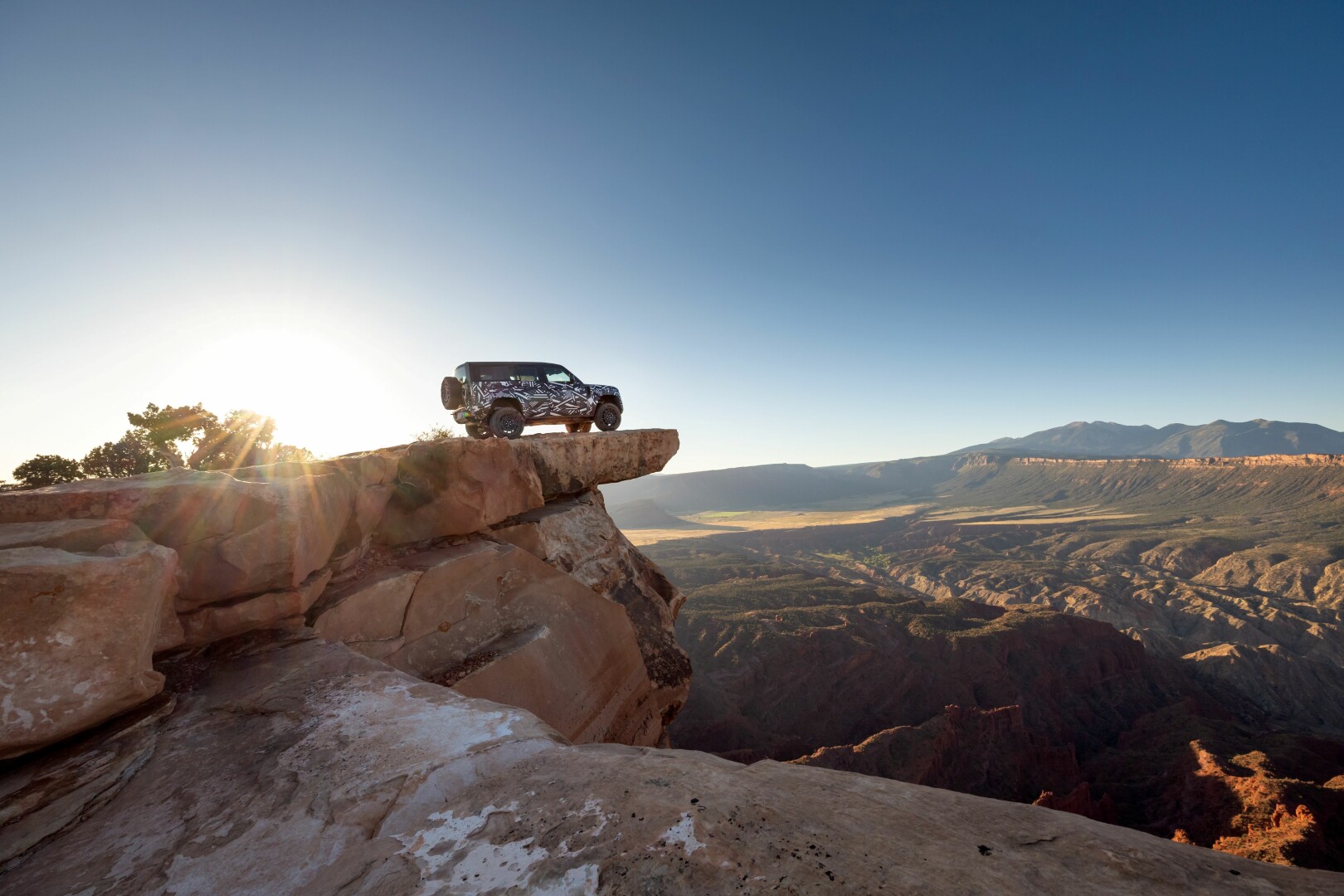 Land Rover Defender Octa on a mountain ledge