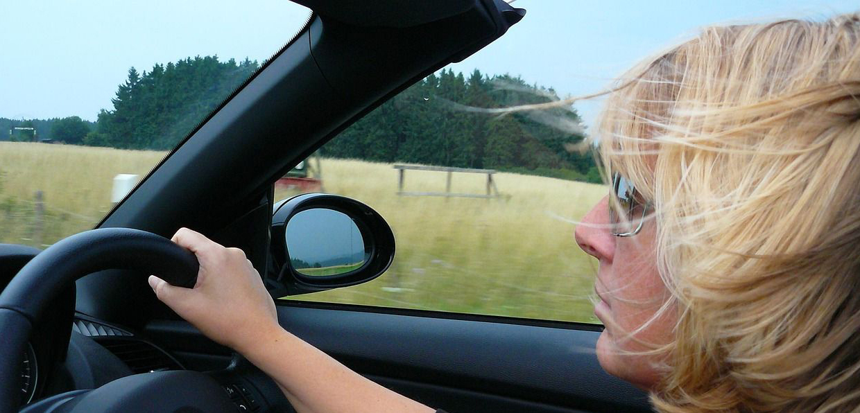 Woman driving open top car