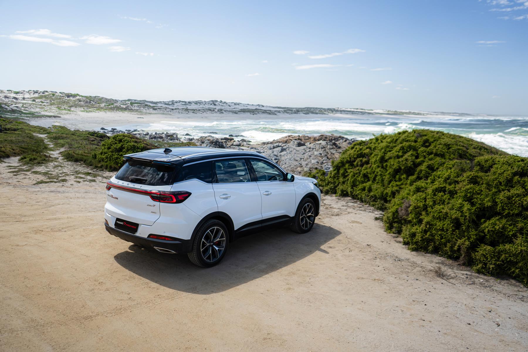 White Chery Tiggo 7 Pro on a beach with the sea in the background
