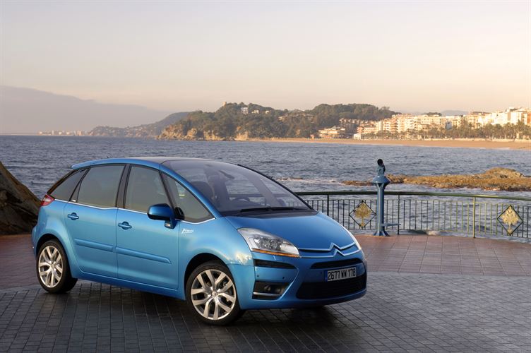 A blue Citroen car near the coast