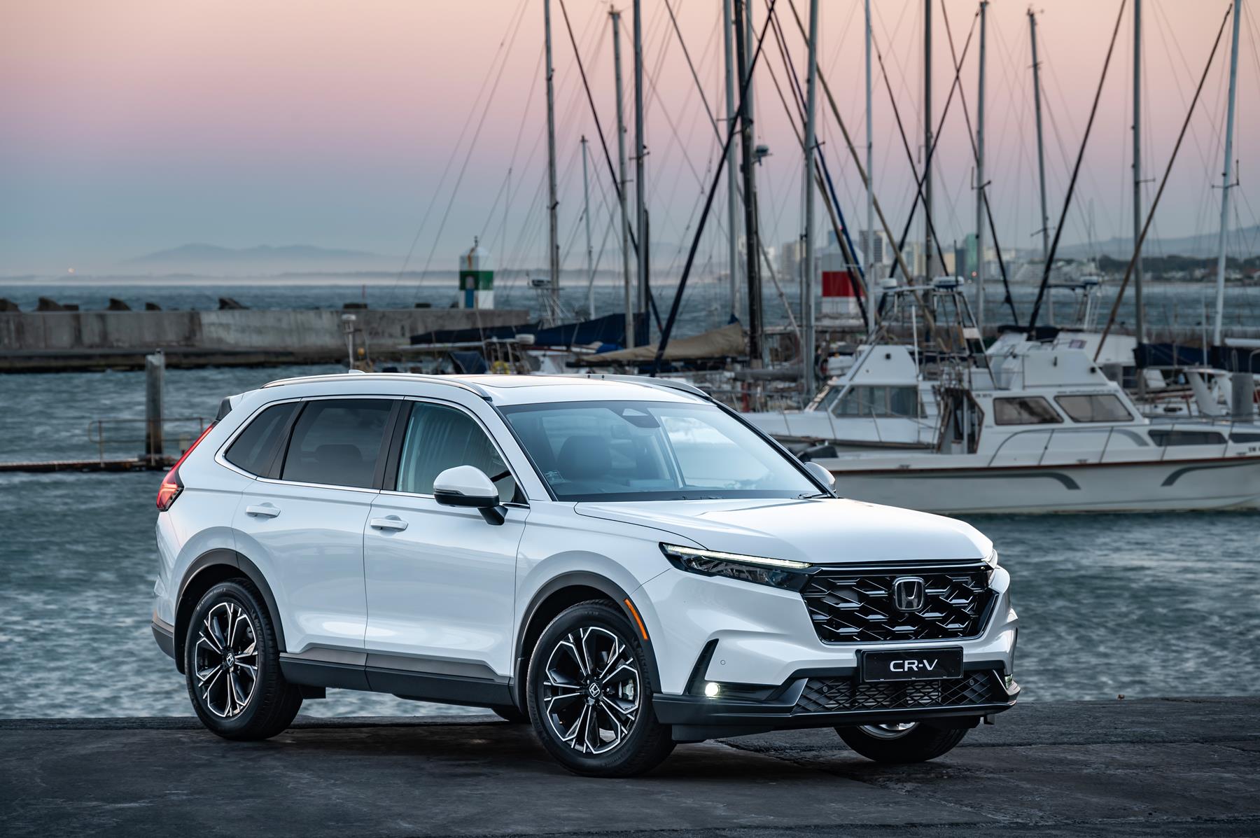 White Honda CR-V near the Cape Town docks with boats in the background