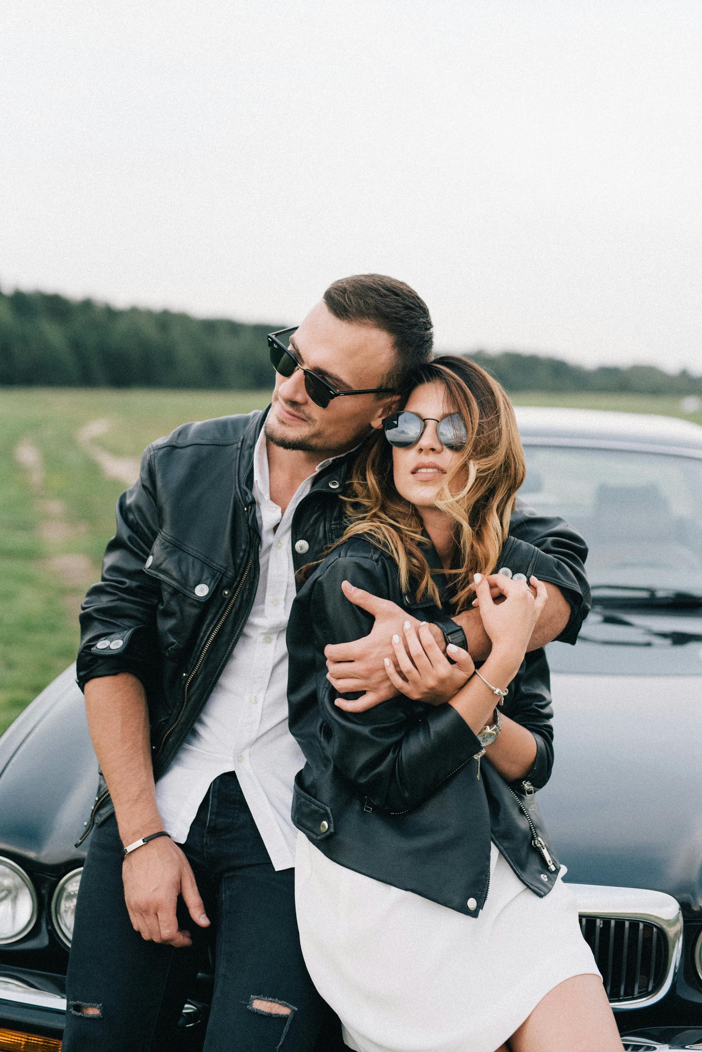 Relaxed couple with car