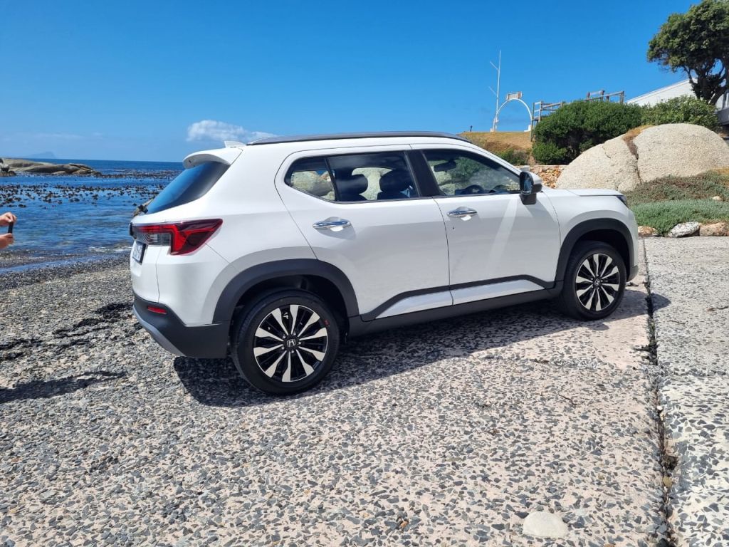 Side view of a white Honda Elevate on a ramp near a beach