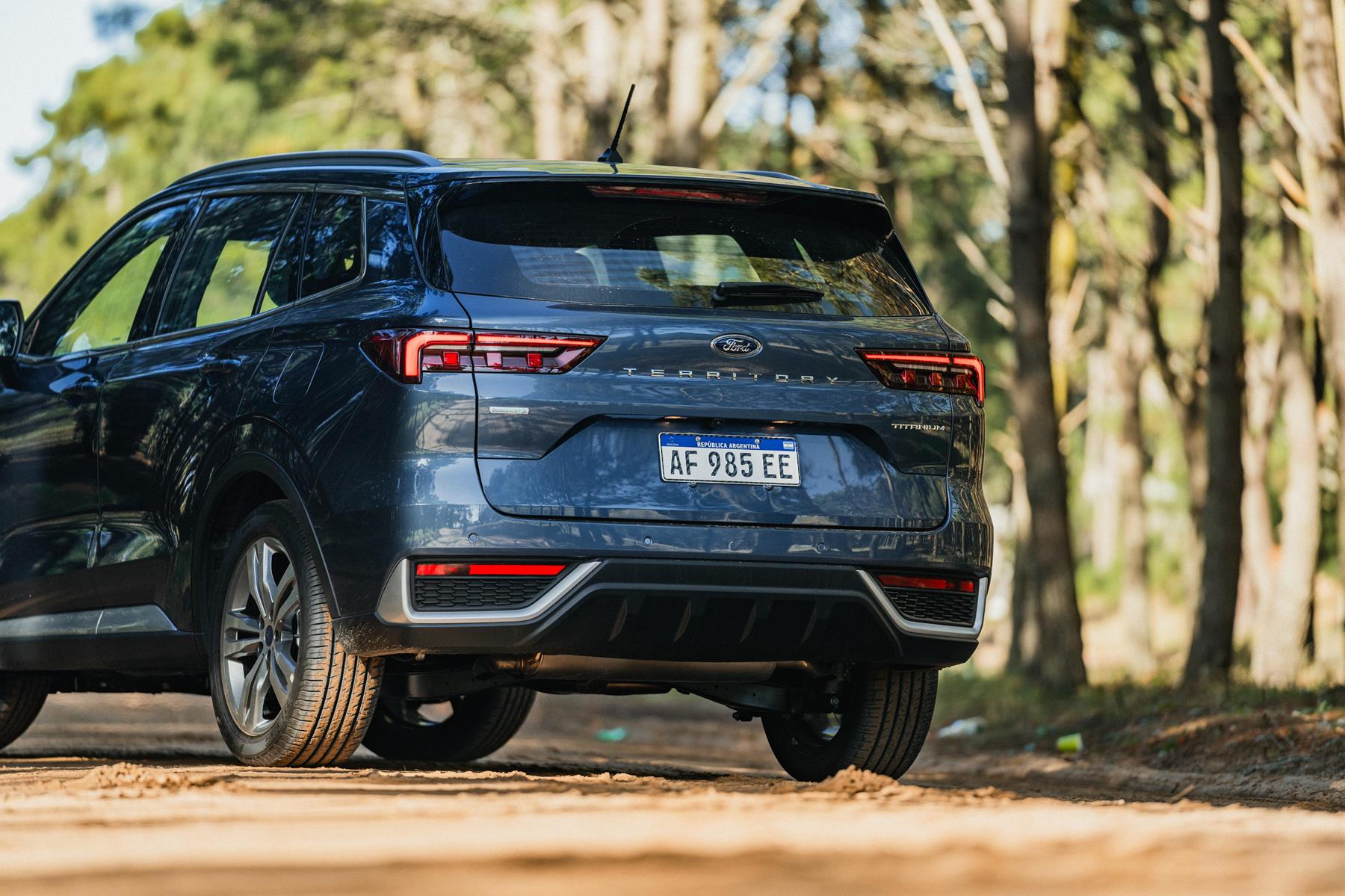 Read view of the New Ford Territory on a dirt road in a forest