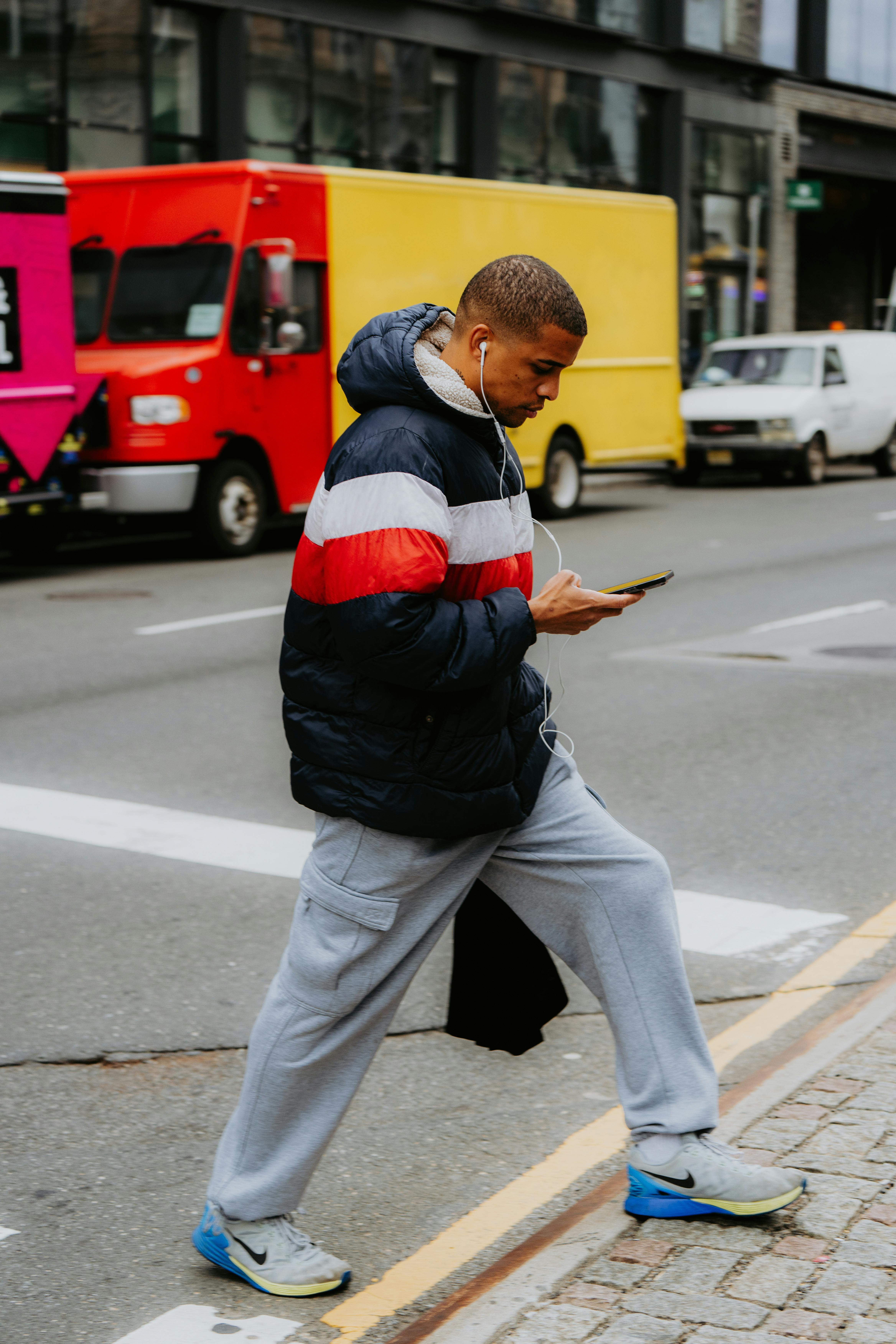 Pedestrain on cell phone with earphones