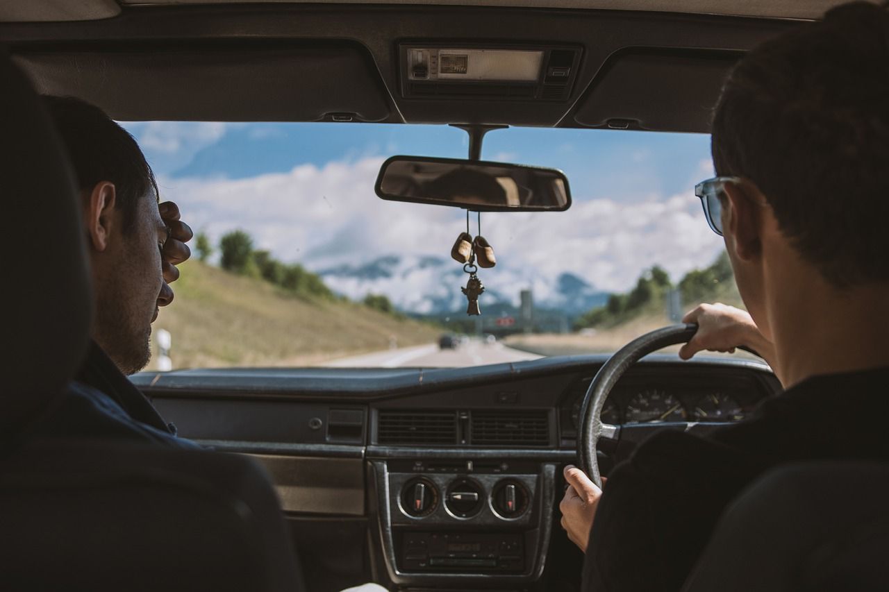 Two people in car on open road