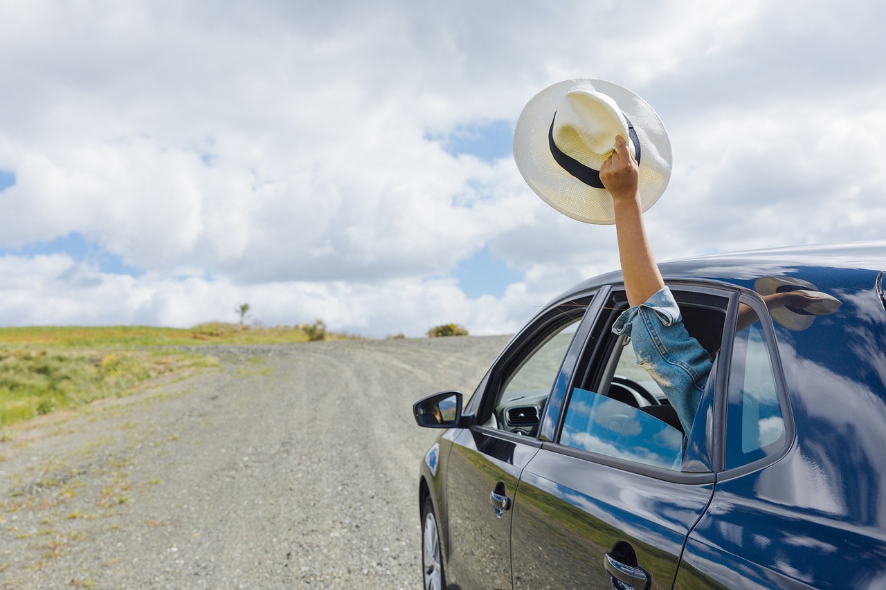 Waving a hat from a moving car