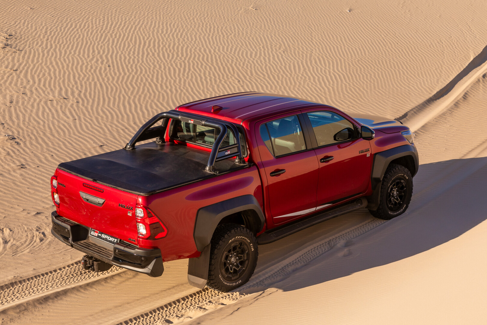 Toyota Hilux GR-S II rear view on sand dune