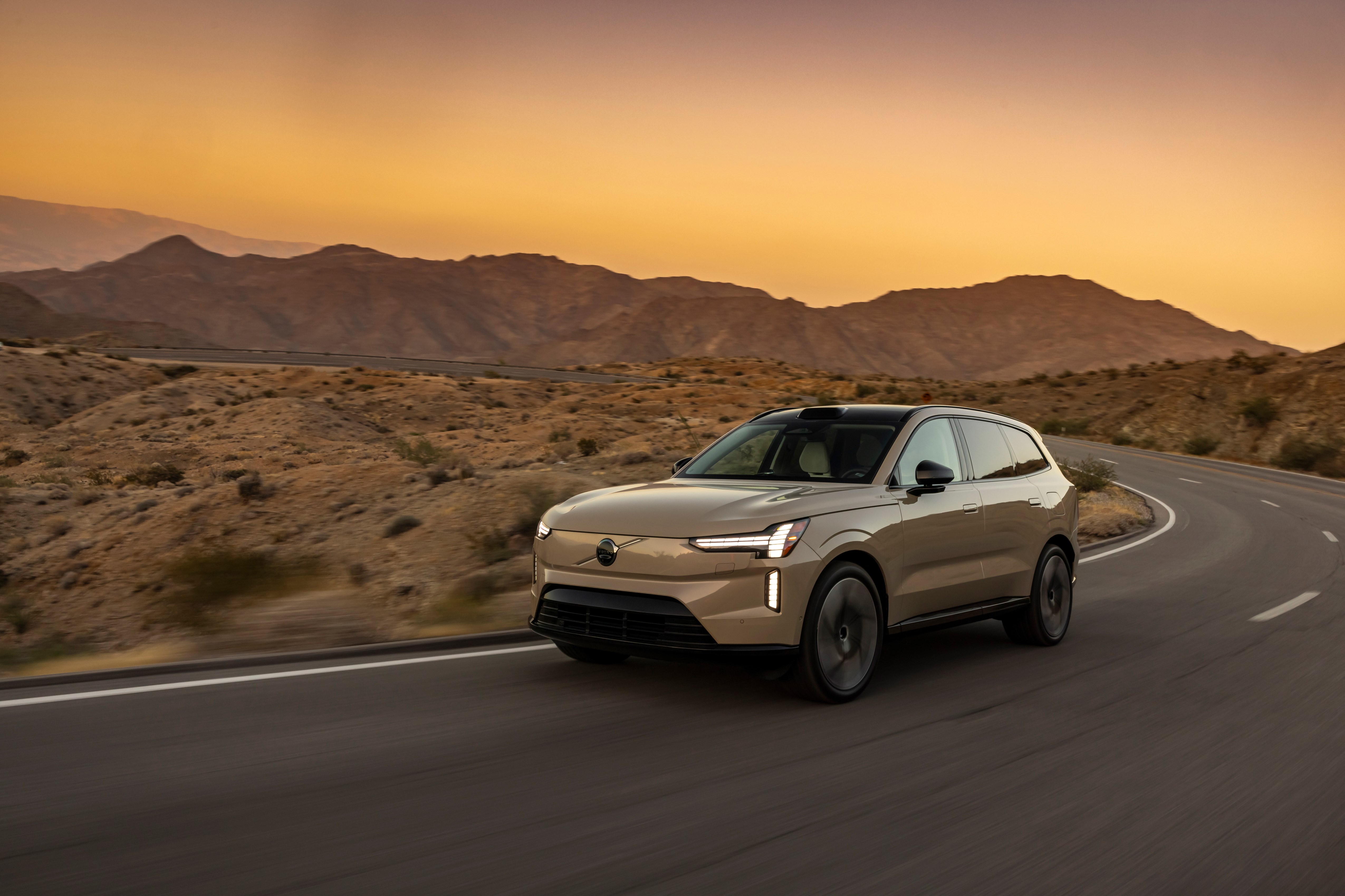 Volvo EX90 on the road sunset background