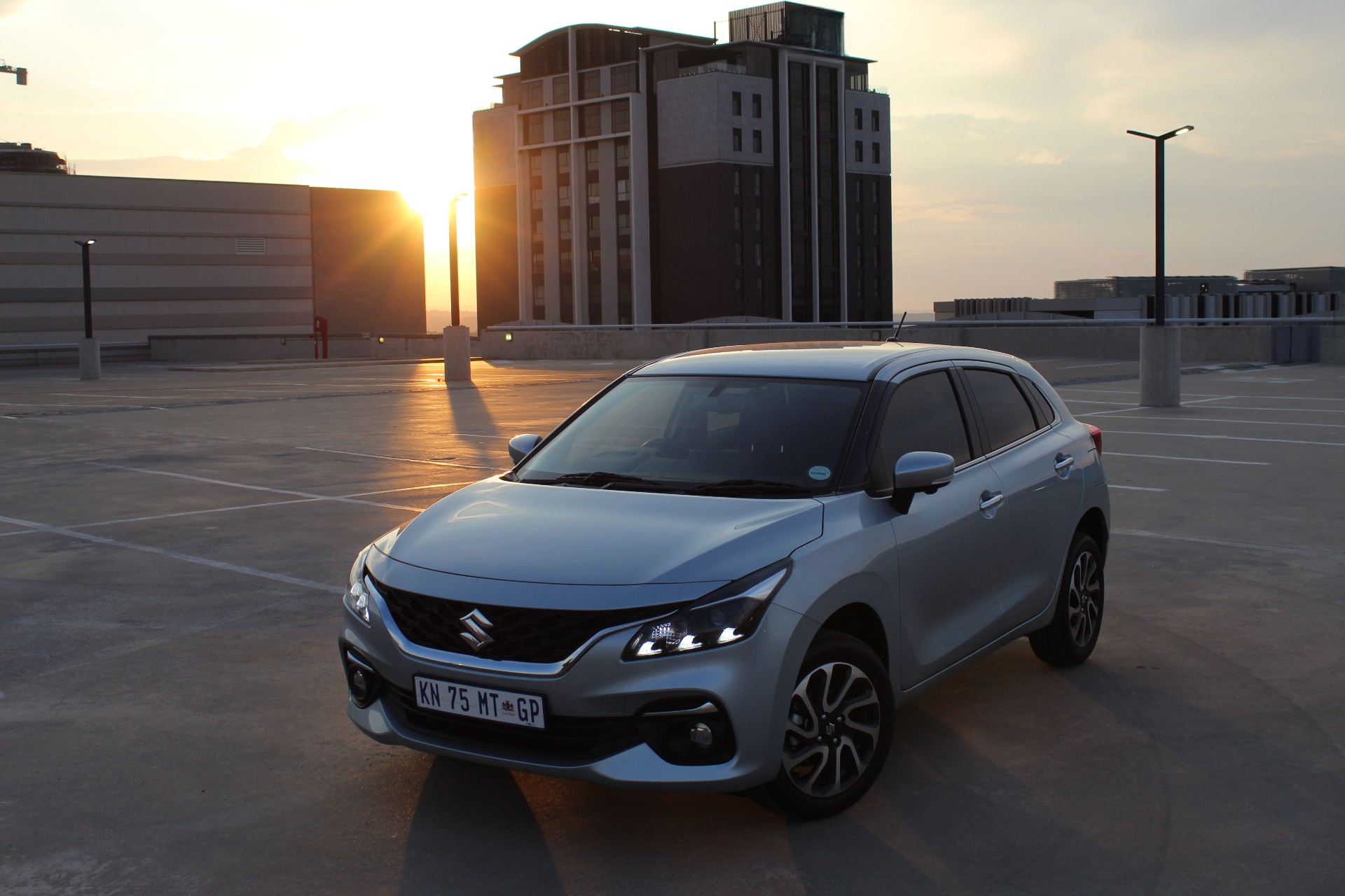 A beauty shot of the Suzuki Baleno with the sun rising in the background