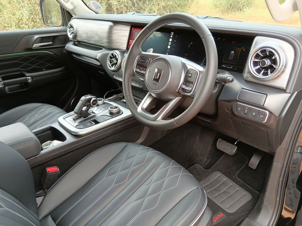 Interior shot of a black GWM Tank 300 showing the drivers postion and the steering wheel