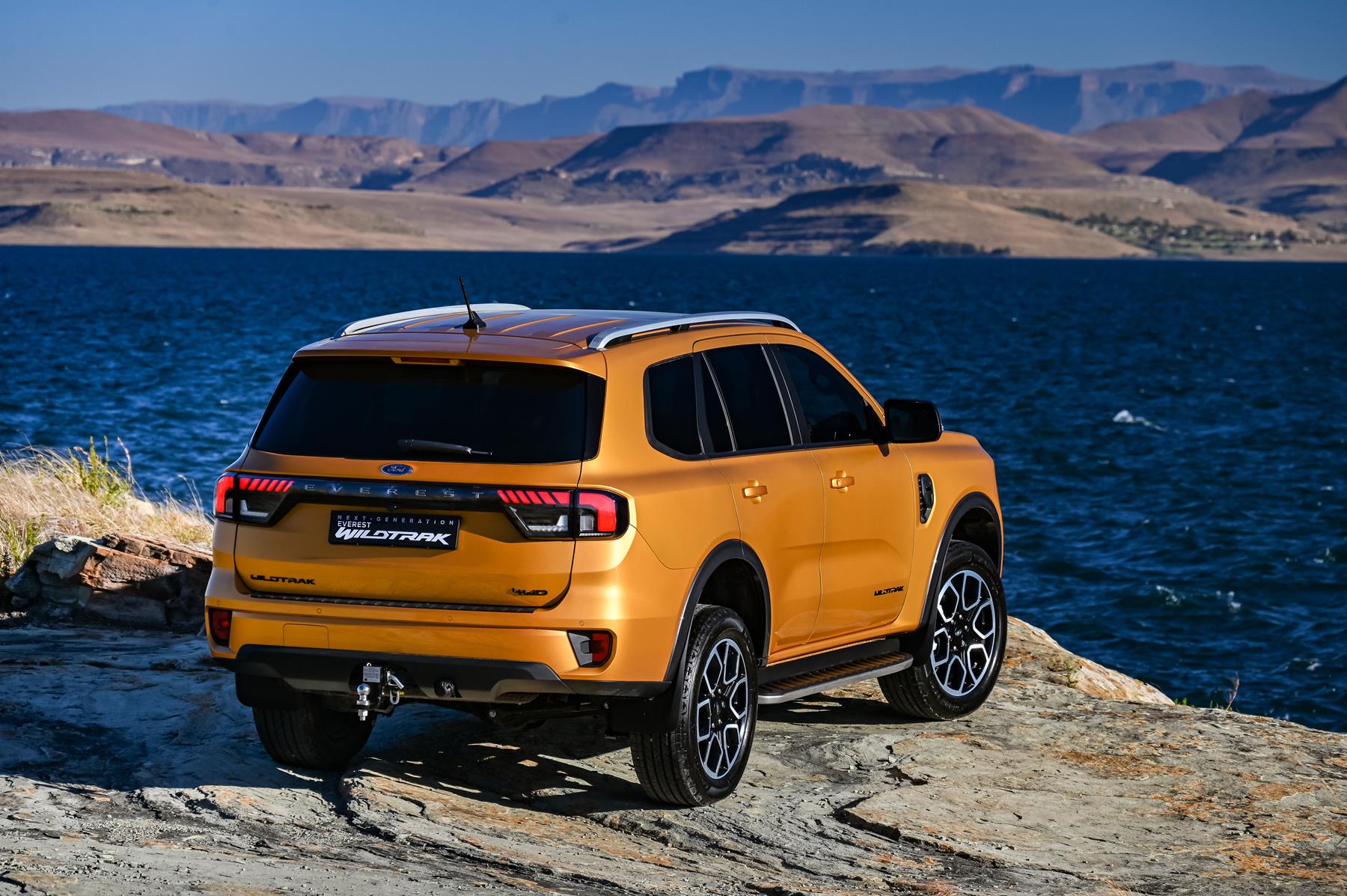 Orange Ford Everest Wildtrack on a mountain top