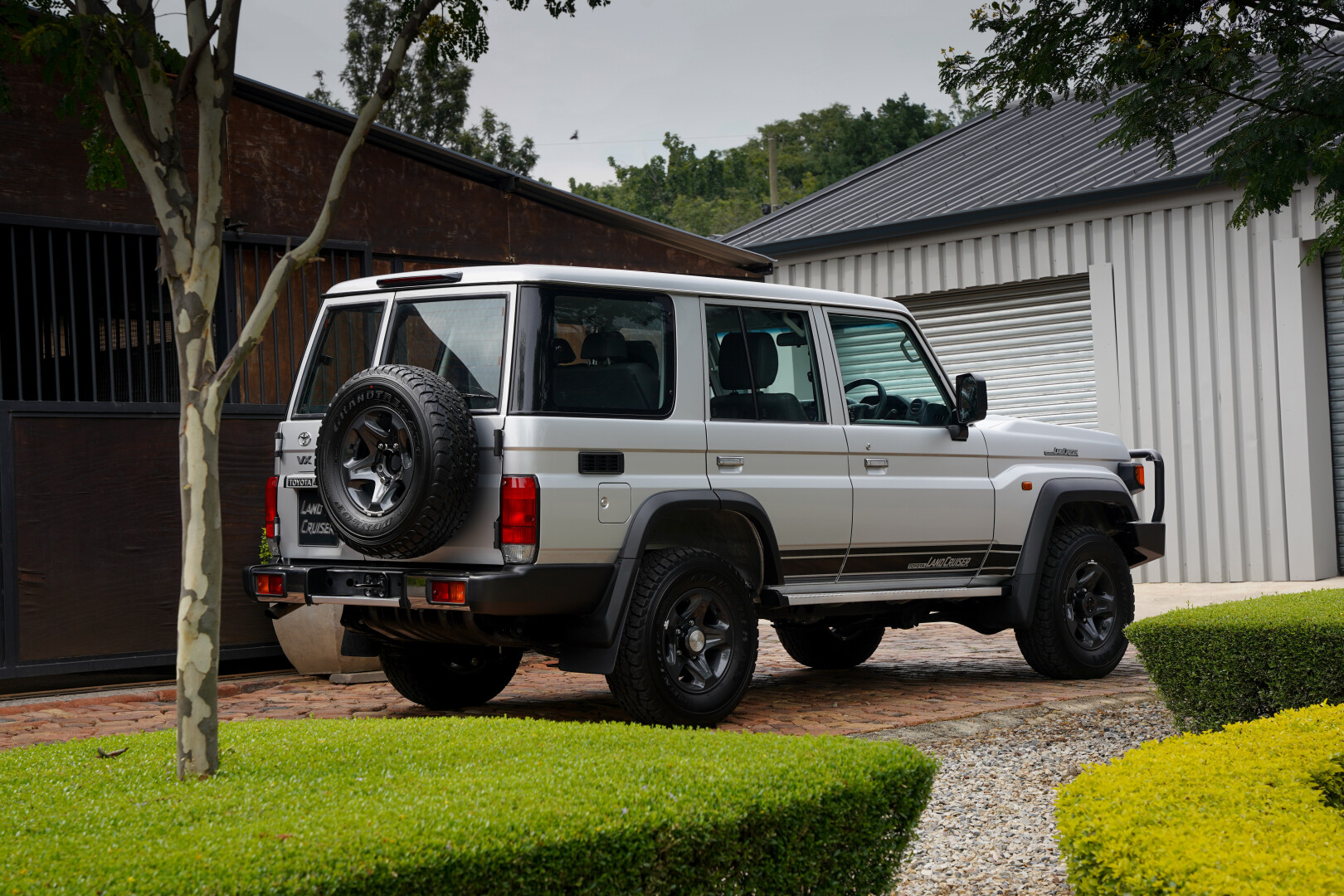 White Land Cruiser 70 Series standing in a drive away